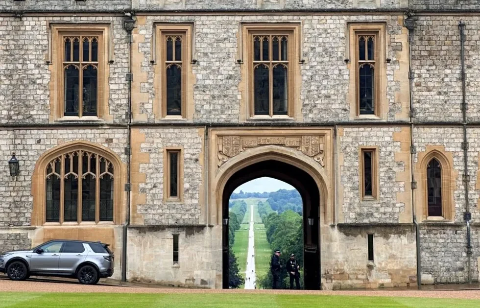 View of Windsor Castle through an archway, with The Long Walk stretching into the distance.