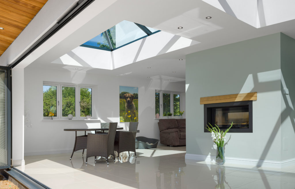 bi folding door and roof lantern from Korniche showing a living area filled with daylight.